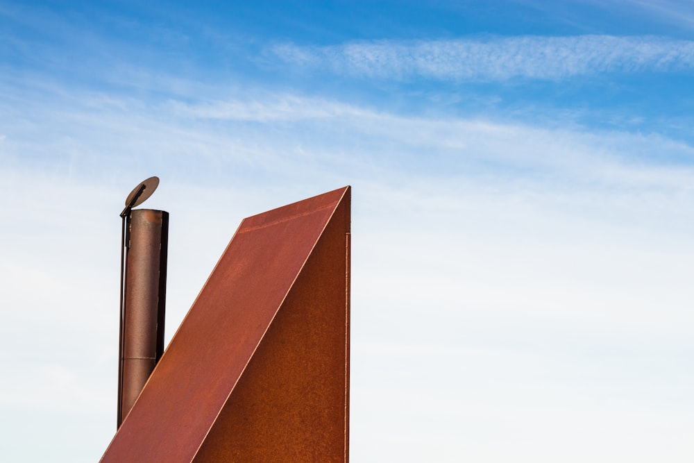 a bird perched on top of a metal structure