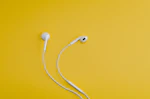Apple EarPods on yellow surface