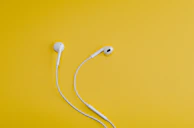 Apple EarPods on yellow surface