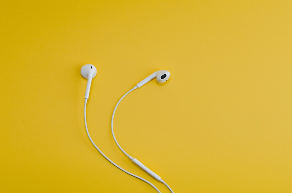 Apple EarPods on yellow surface