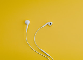 Apple EarPods on yellow surface