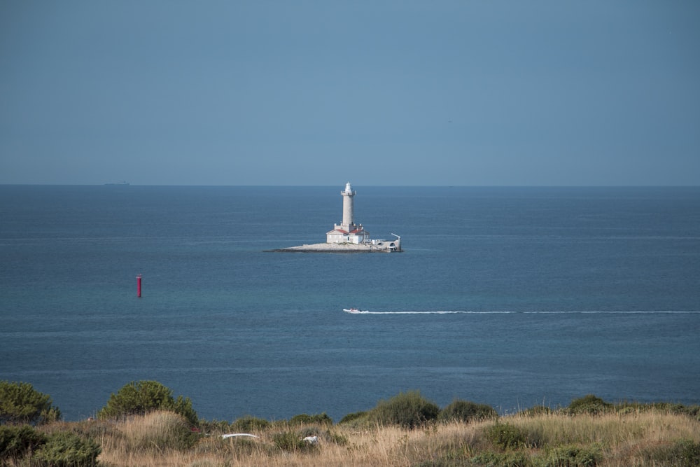 white ship on sea under blue sky during daytime