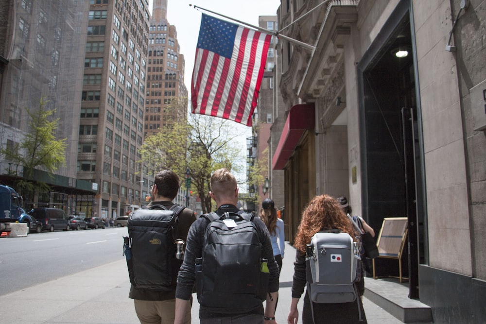 man and woman walking on street during daytime