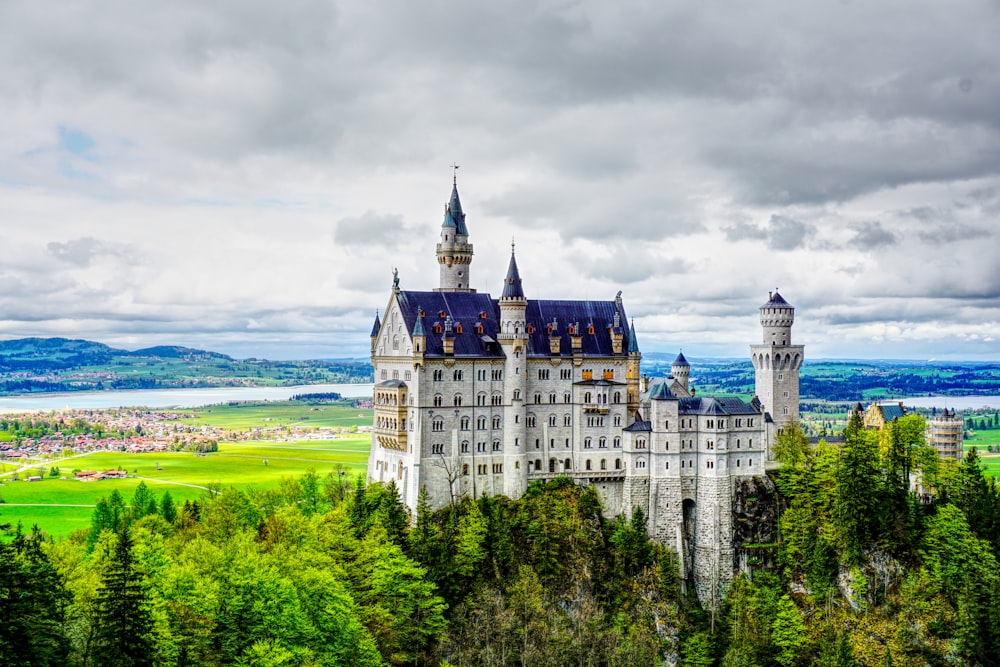 white and blue castle under gray clouds