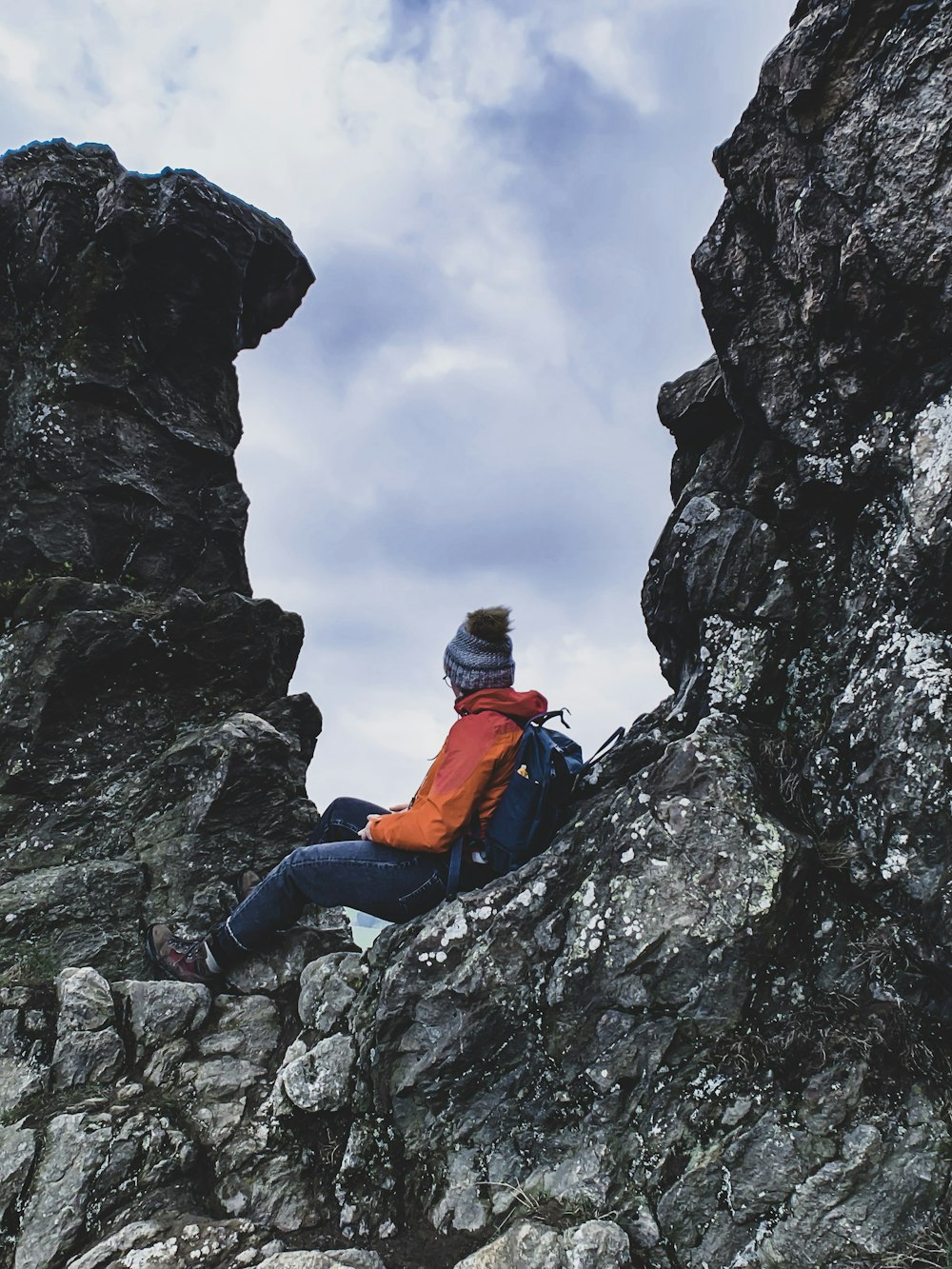 man sitting on rock