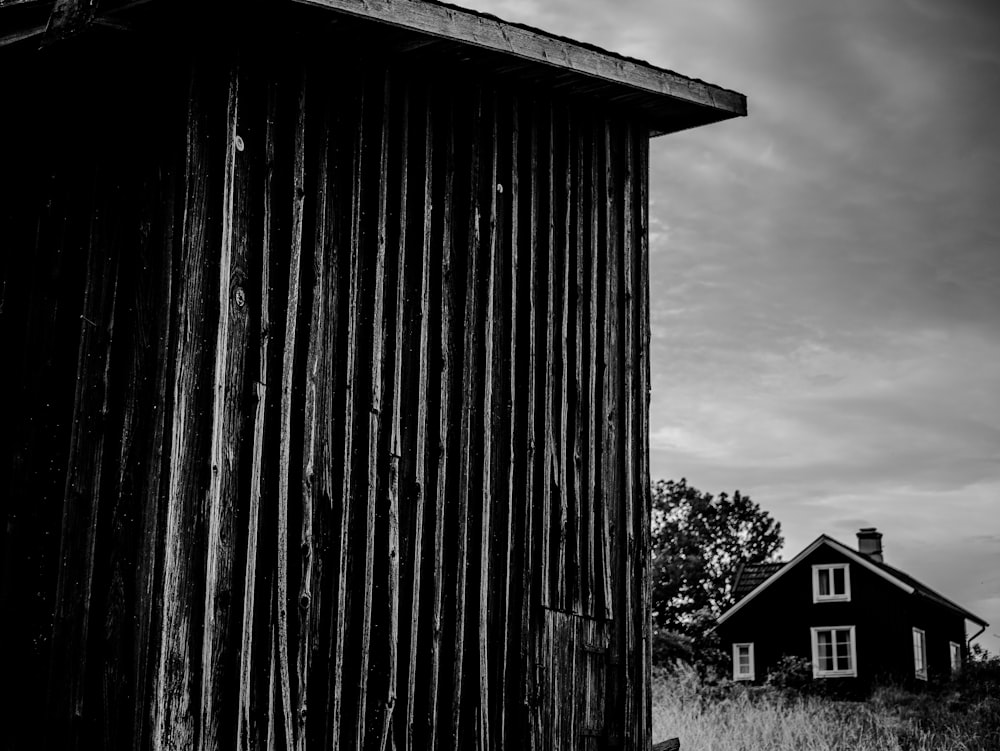 grayscale photo of house near shed