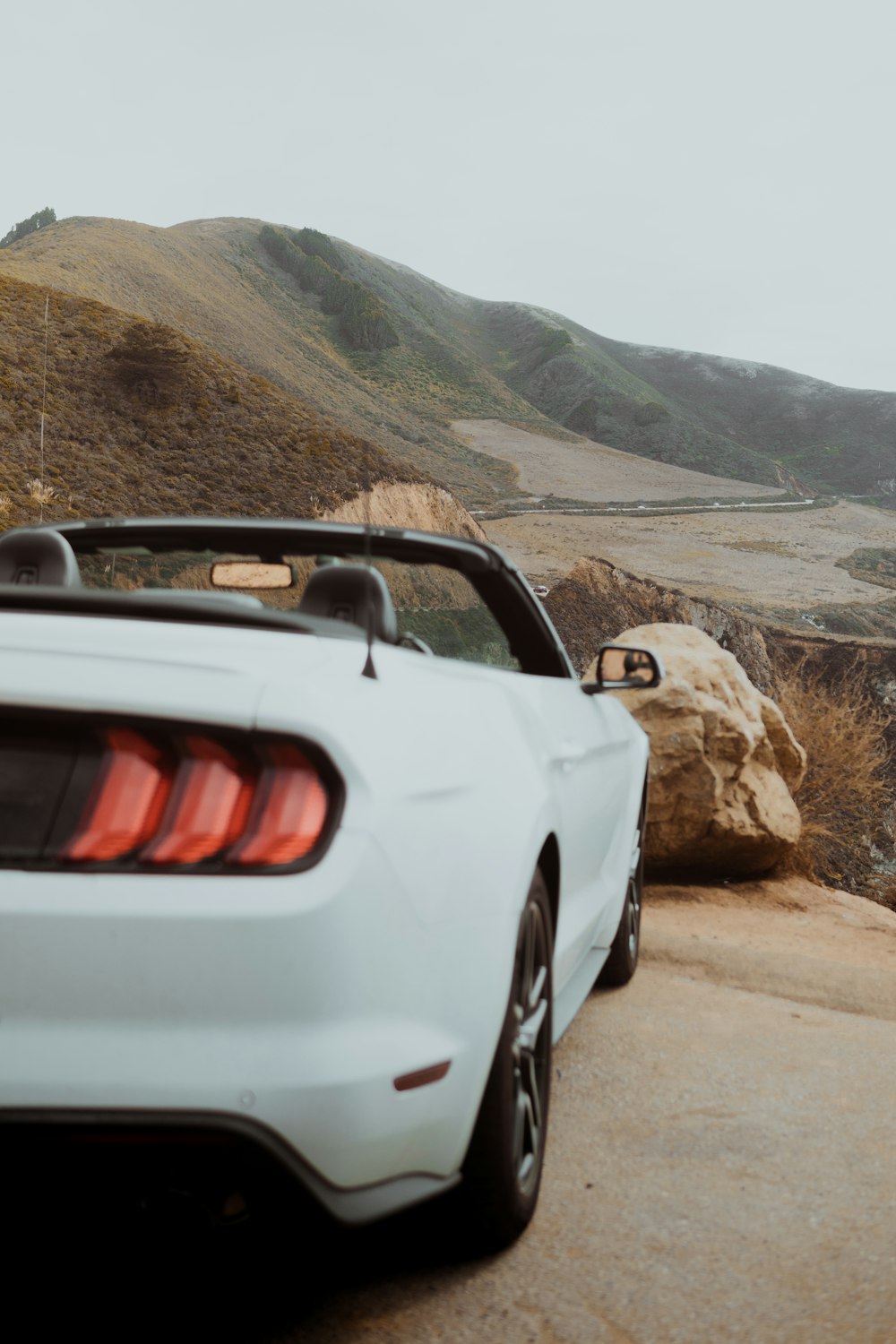 white convertible on rock