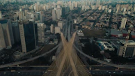 Aerial view of a newly completed cable-stayed bridge in Dubai with city skyline in the background.