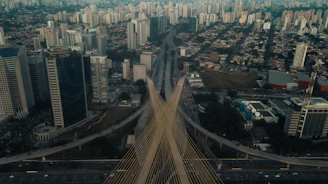 Aerial view of a newly completed cable-stayed bridge in Dubai with city skyline in the background.