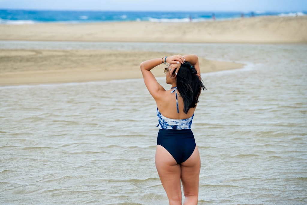 Beach swimwear photoshoot with natural ocean waves in the background