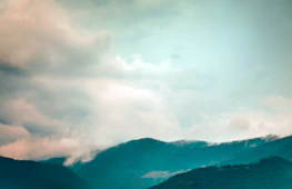 A serene outdoor scene with changing weather elements like sun, clouds, and rain.