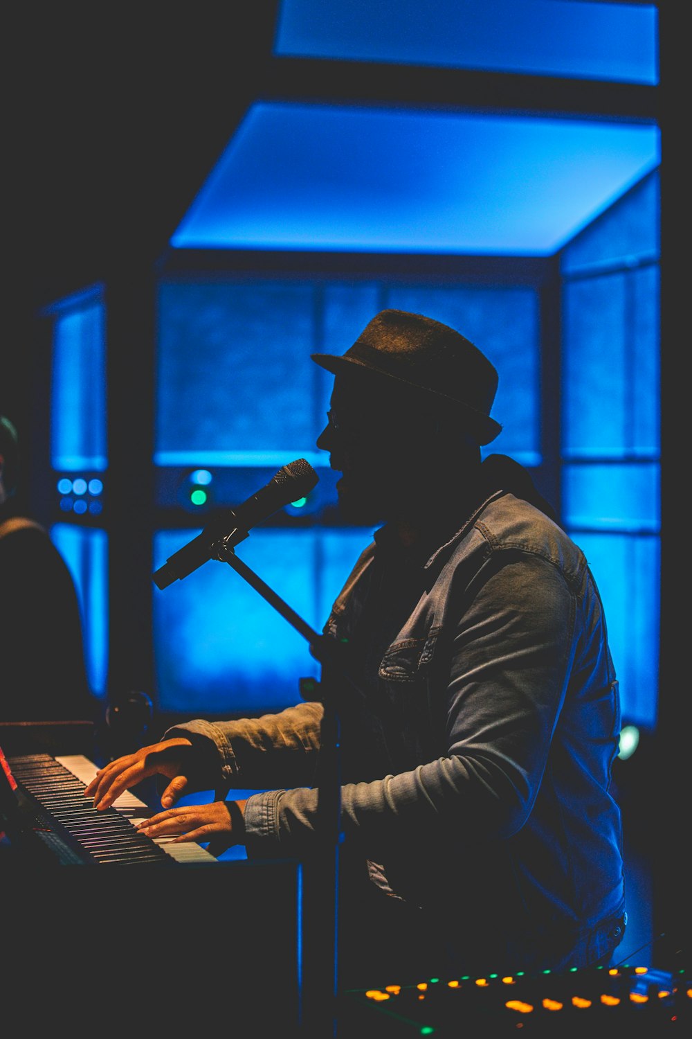 man singing while playing piano