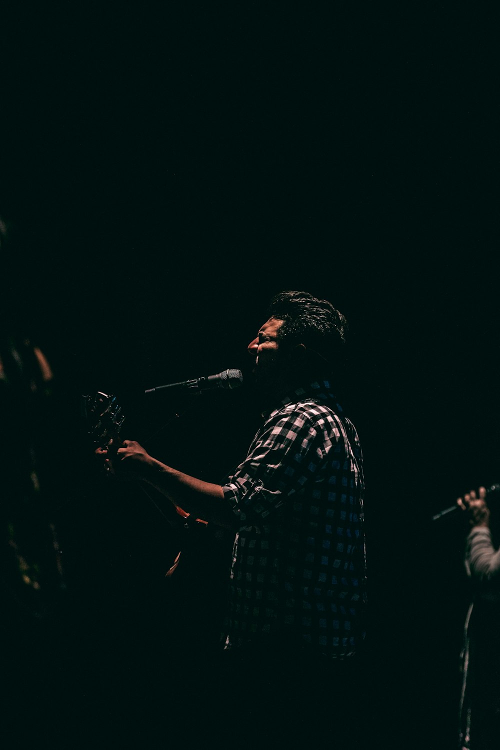 man playing guitar while singing