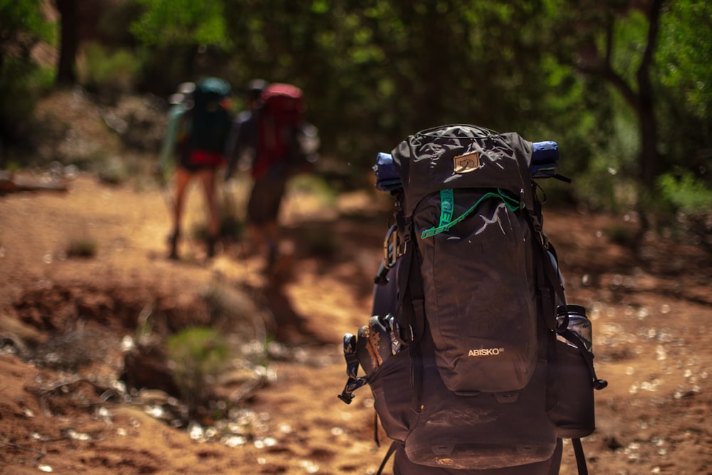 man carrying black hiking bag