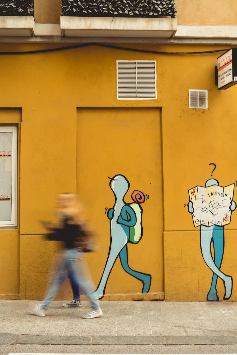 walking human shaped painted wall