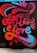 A vibrant graffiti artwork on a brick wall spells out 'Spread the Love' in stylized, flowing letters. The design is a mix of red, pink, and blue colors with dynamic curves and shapes, conveying a sense of movement and energy.