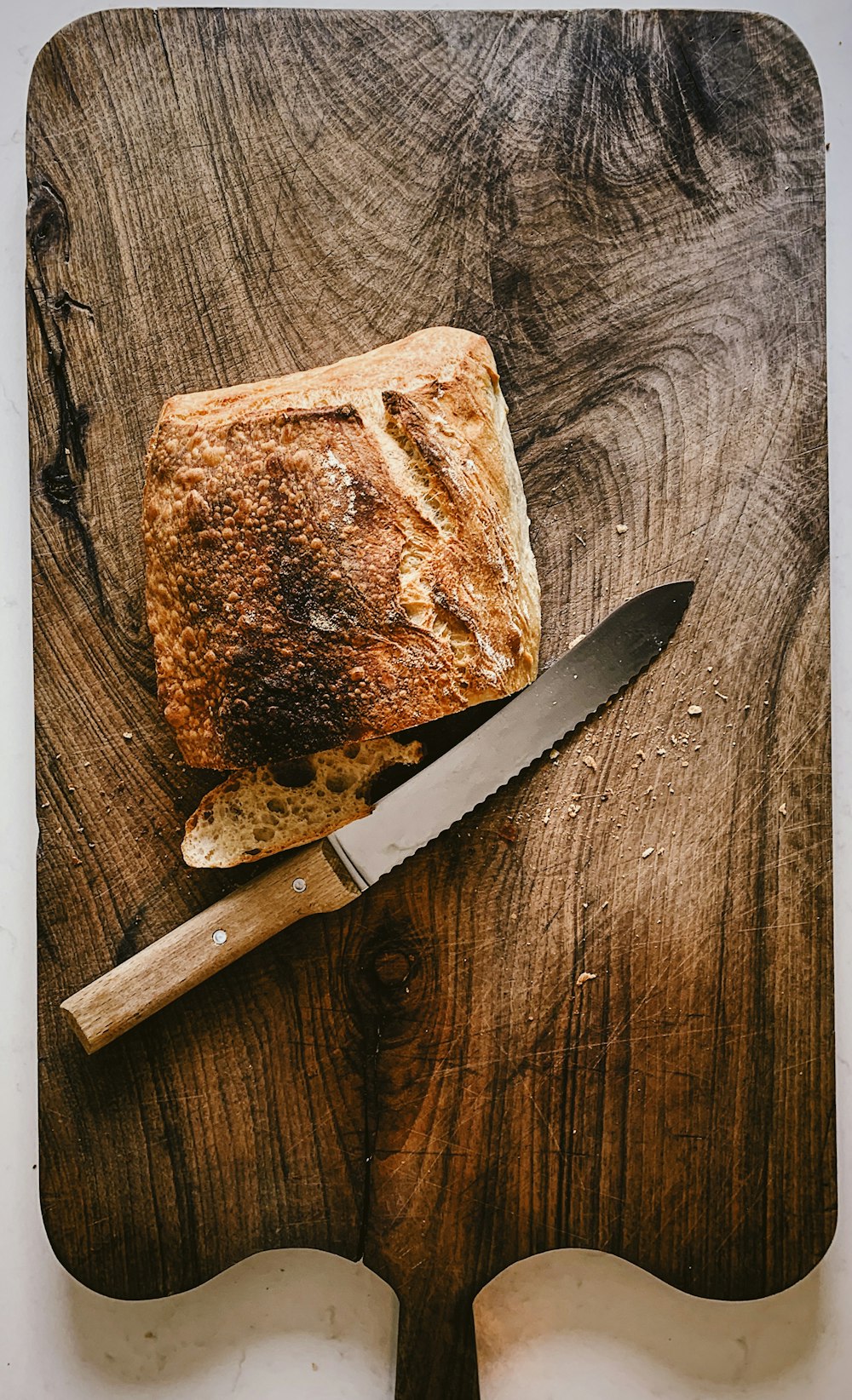 bread beside knife on chopping board