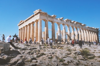 people near ancient structure during daytime