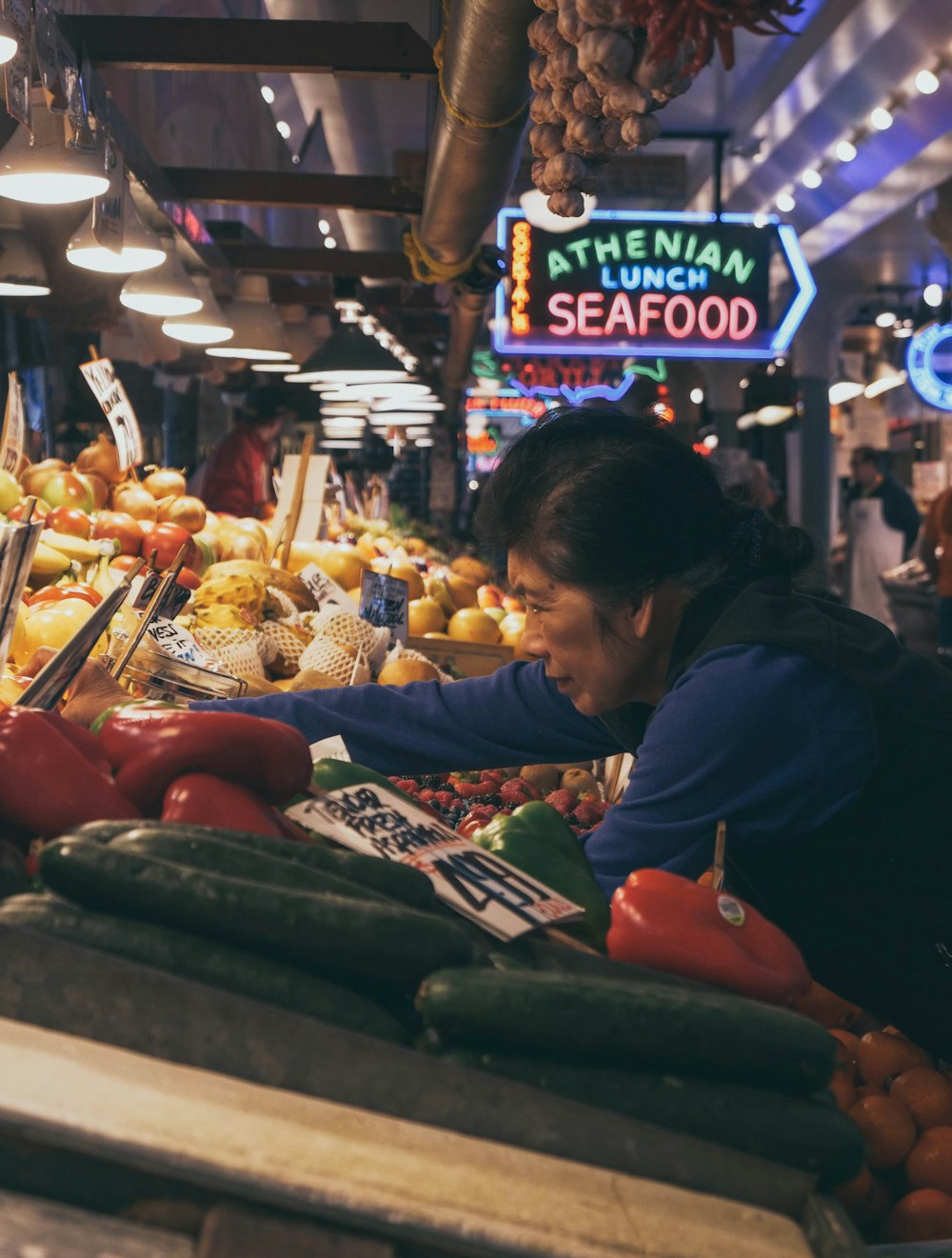 woman reaching vegetable