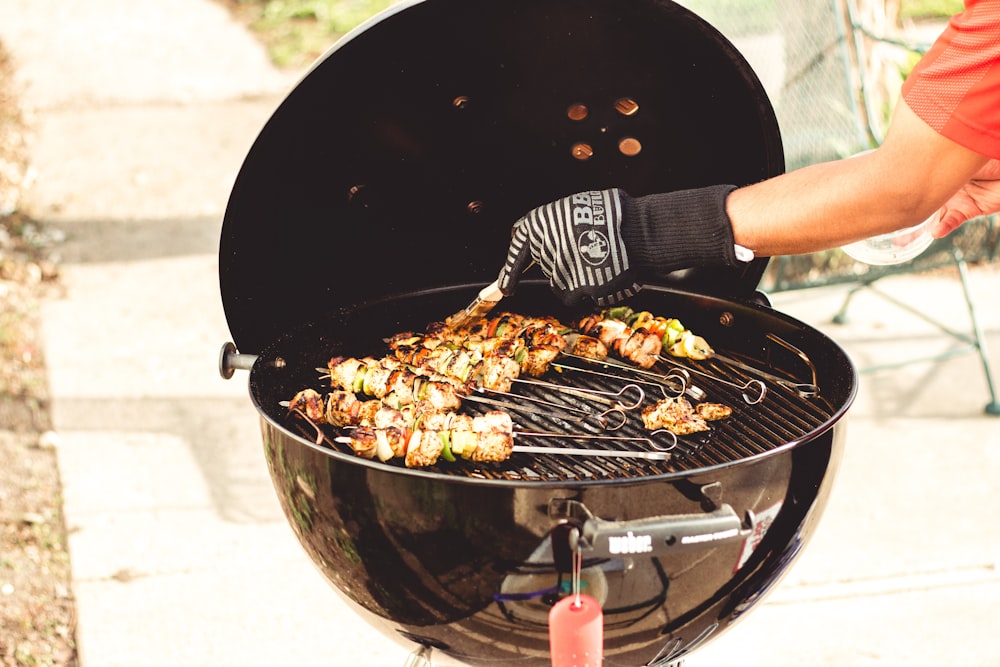 person grilling food