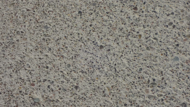 Close-up of a decorative concrete slab with subtle Hawaiian-inspired textures and earth tones.