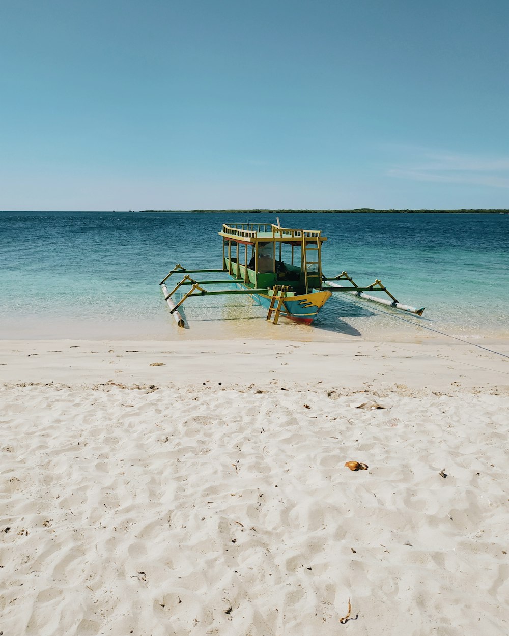 boat on shore during daytime