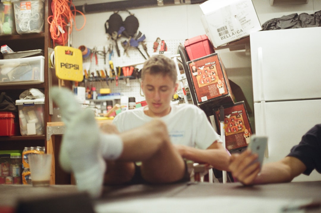 man sitting and putting both feet at the table