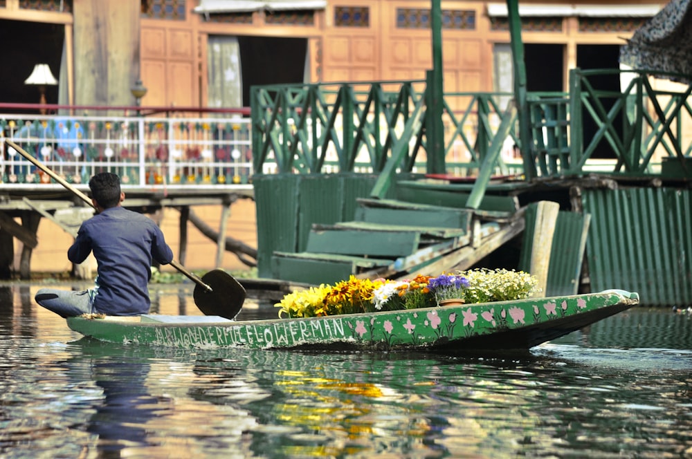 man on boat with flowers