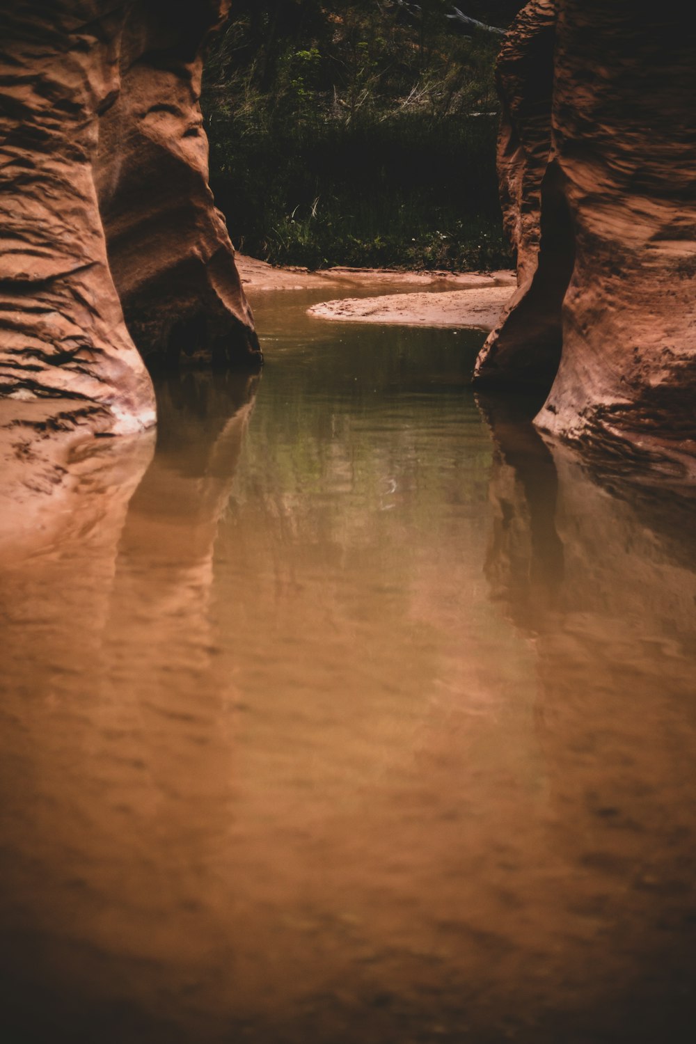 calm body of water between rock formation