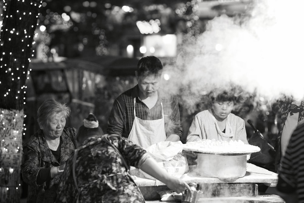 grayscale photo of man wearing aprin