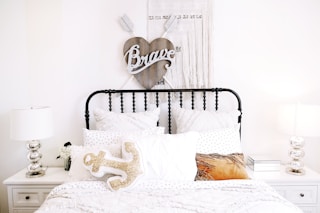 pillows on bed beside headboard