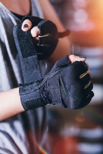 person wearing black fingerless gloves