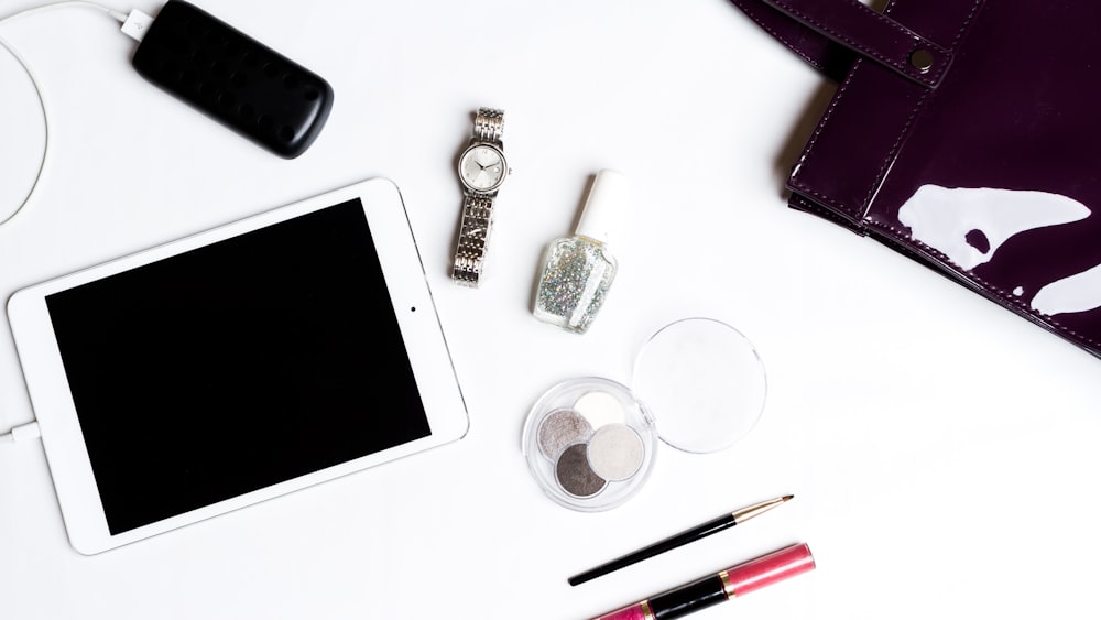 silver iPad on white surface