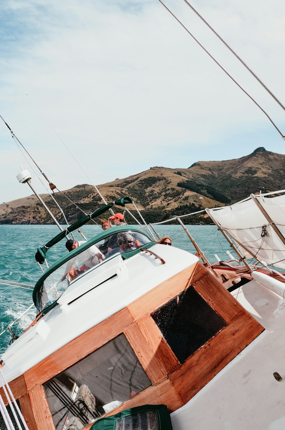 people riding cabin cruiser boat near island