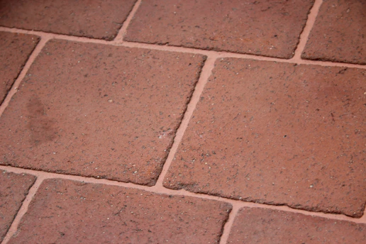Close-up of epoxy grout application between floor tiles in a modern bathroom