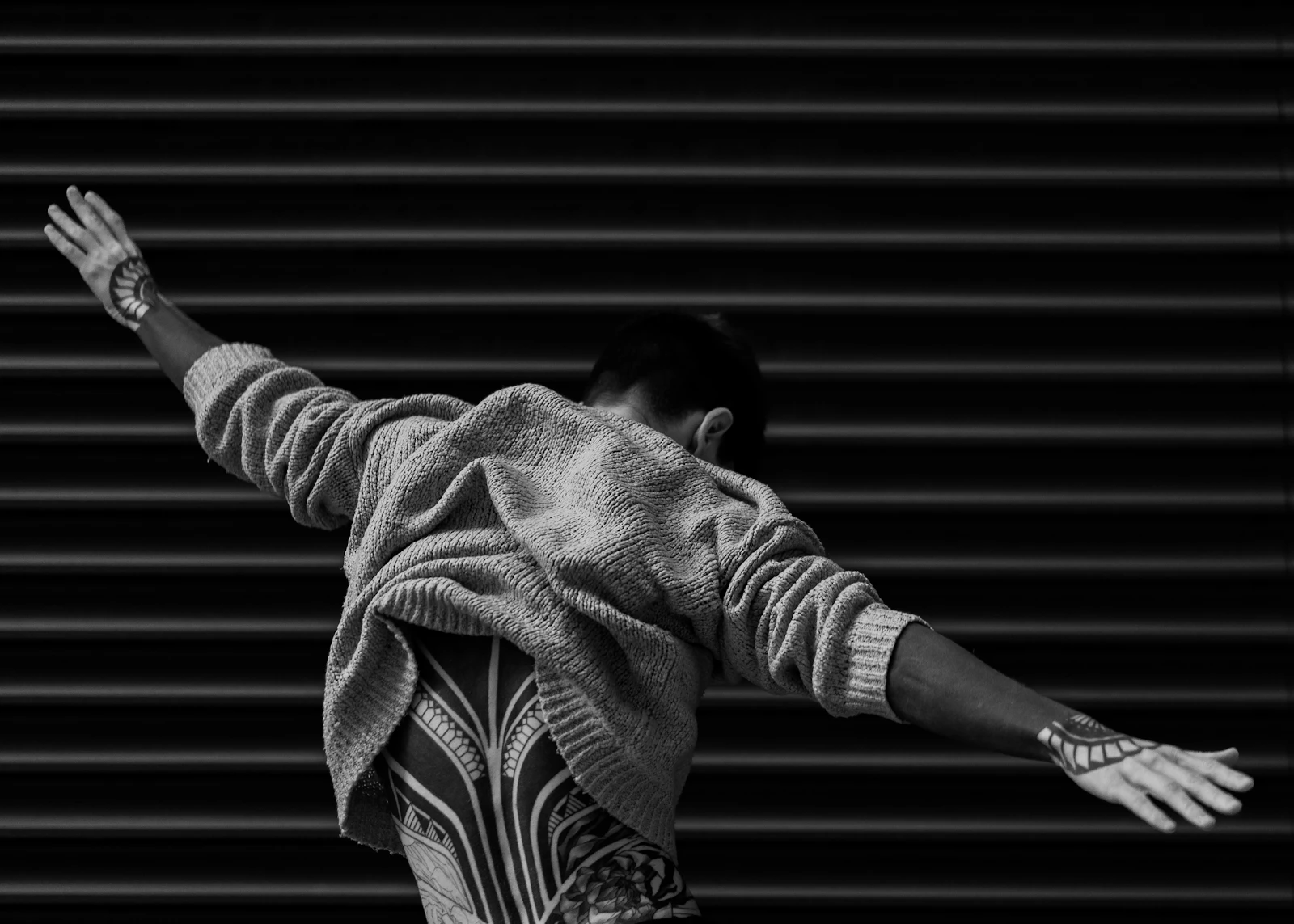 Grayscale photo of a man wearing a jacket