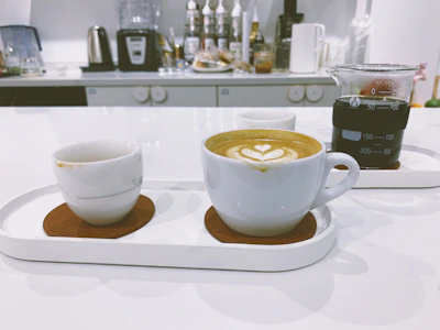 A sleek, modern kitchen setup displaying a stylish coffee maker and artisanal mugs.