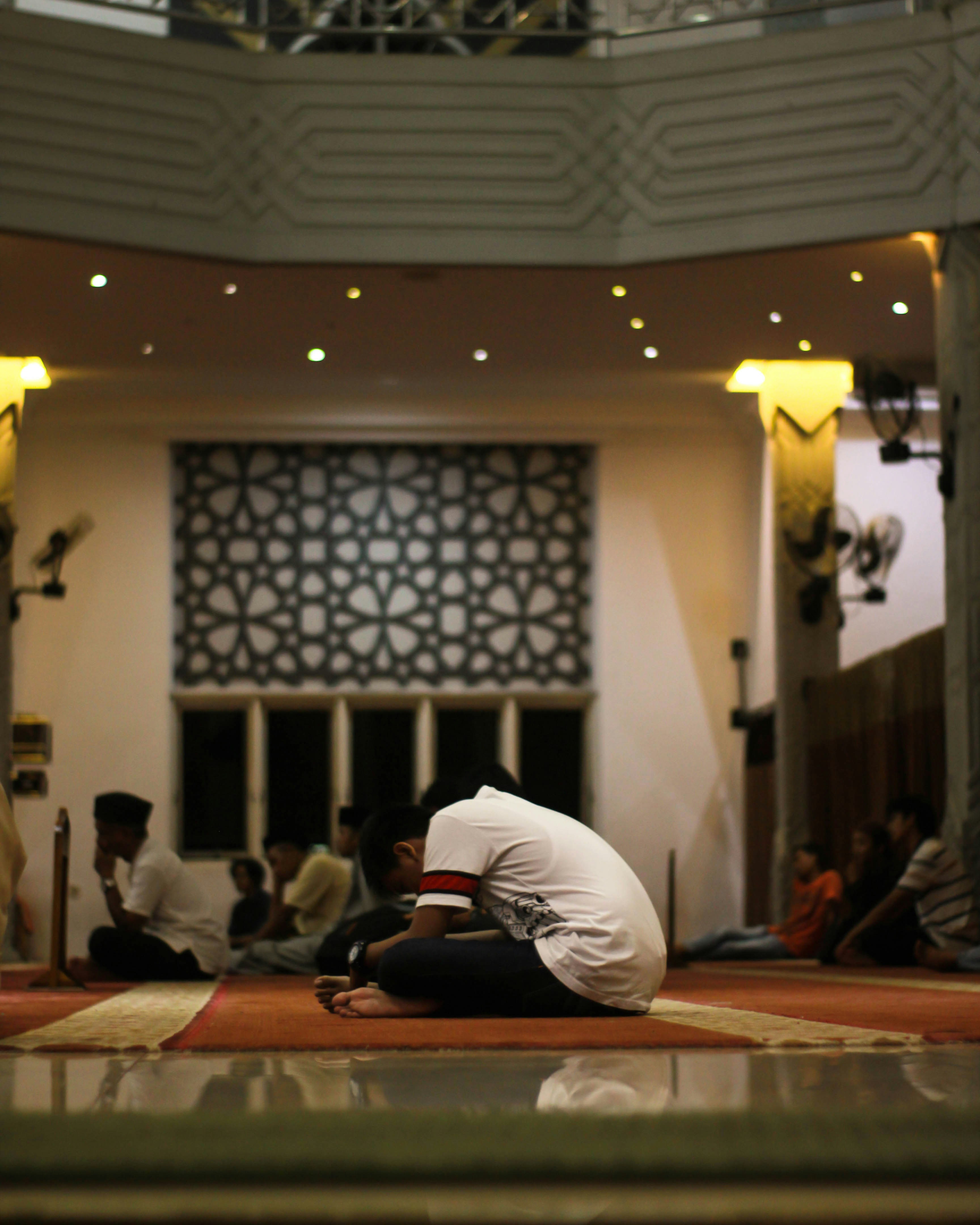 men sit in the mosque