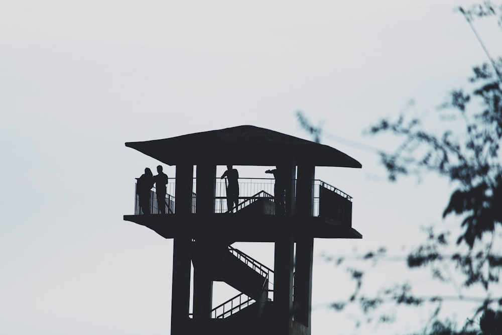 people in the watch tower at daytime