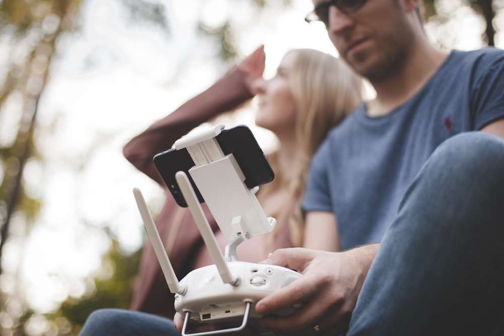 man using white controller close-up photography