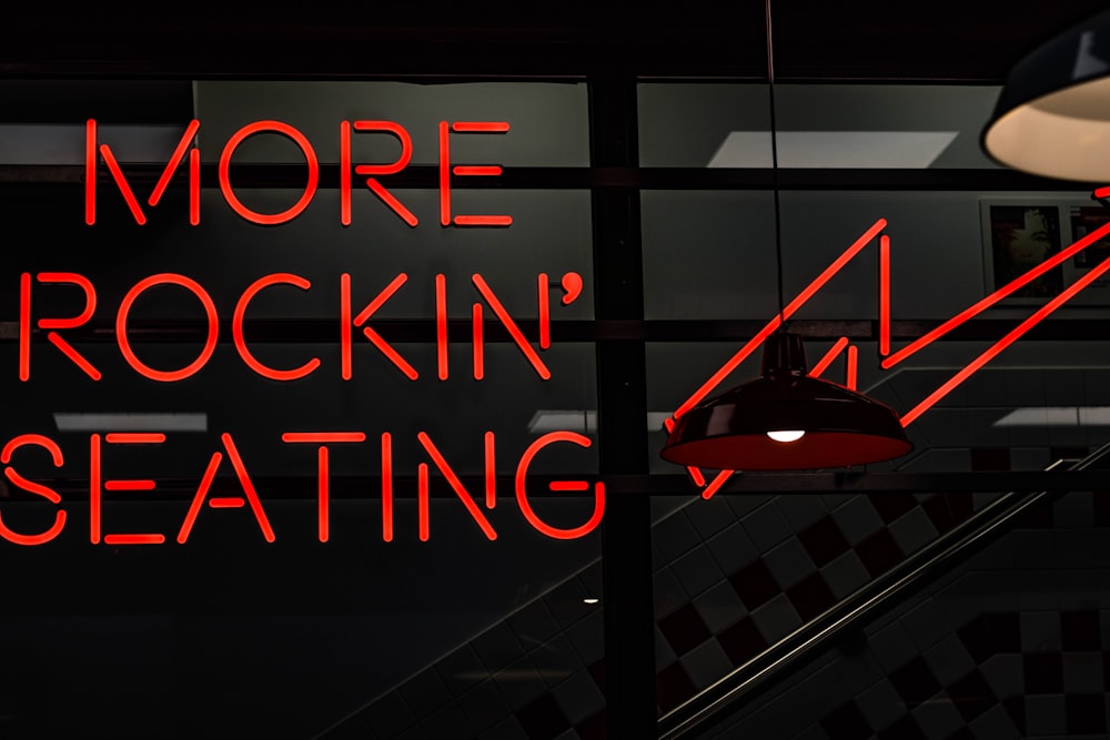 a red neon sign that reads more rockin'seating