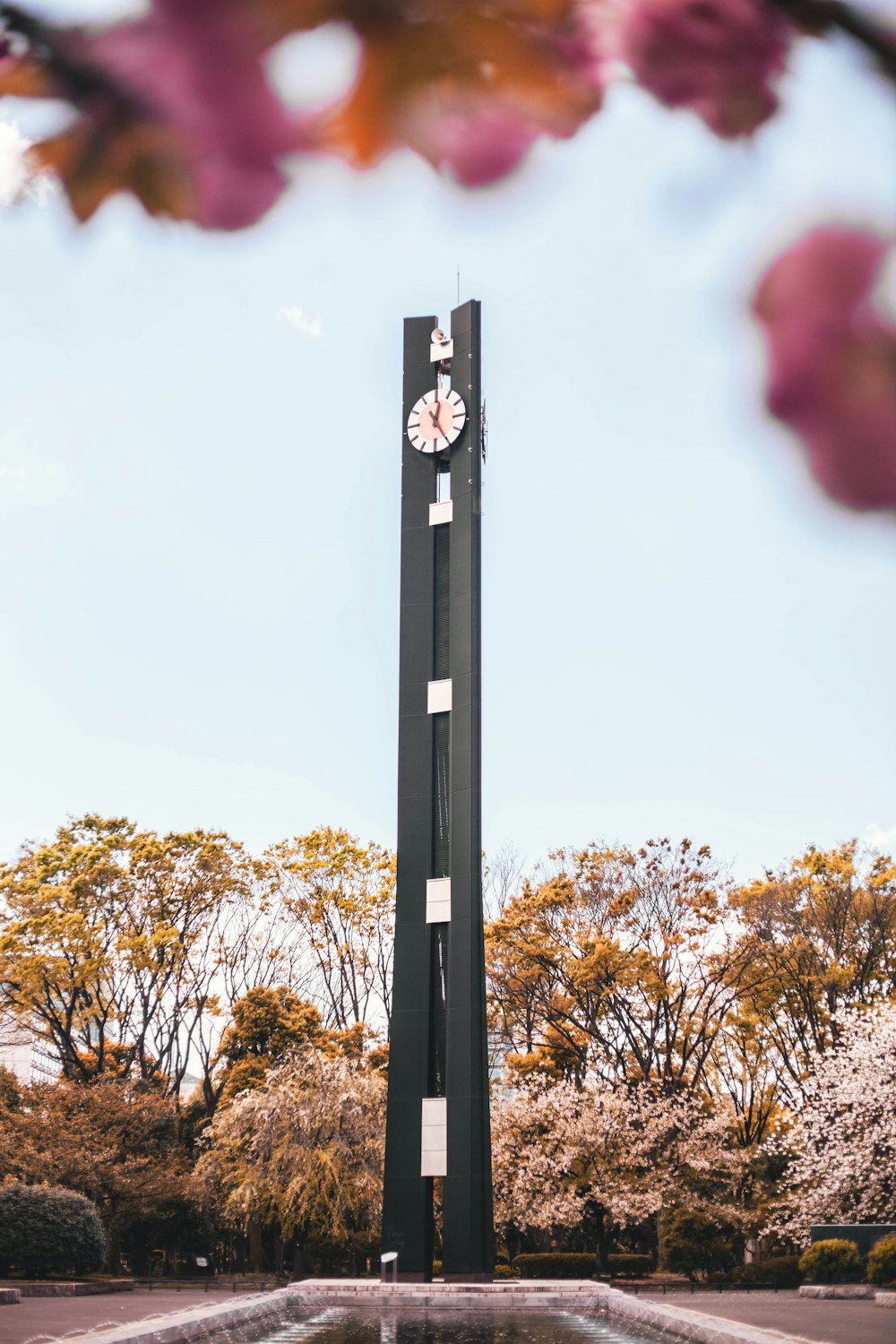 grey concrete clock tower at the park