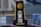 A large trophy stands prominently on a table, featuring the NCAA logo at the top and labeled '2019 Division I Lacrosse Championship' at the center. The base of the trophy reads 'National Champion.' On either side are informational signs about ticket sales for the championship event, with promotional images and details.
