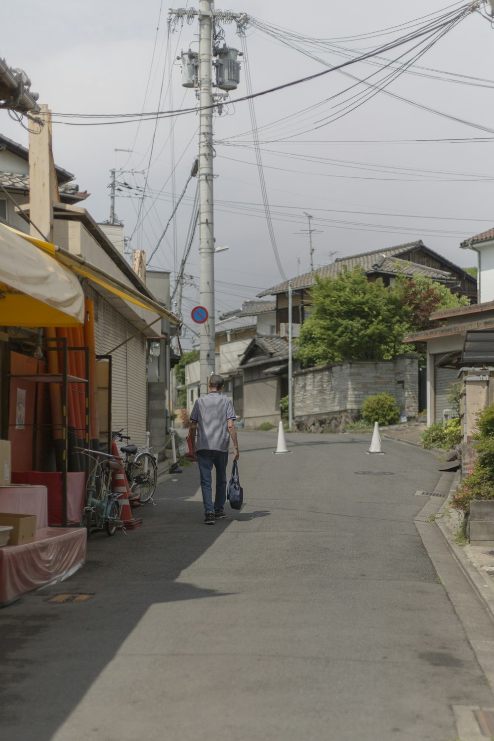 man walking on road at daytime