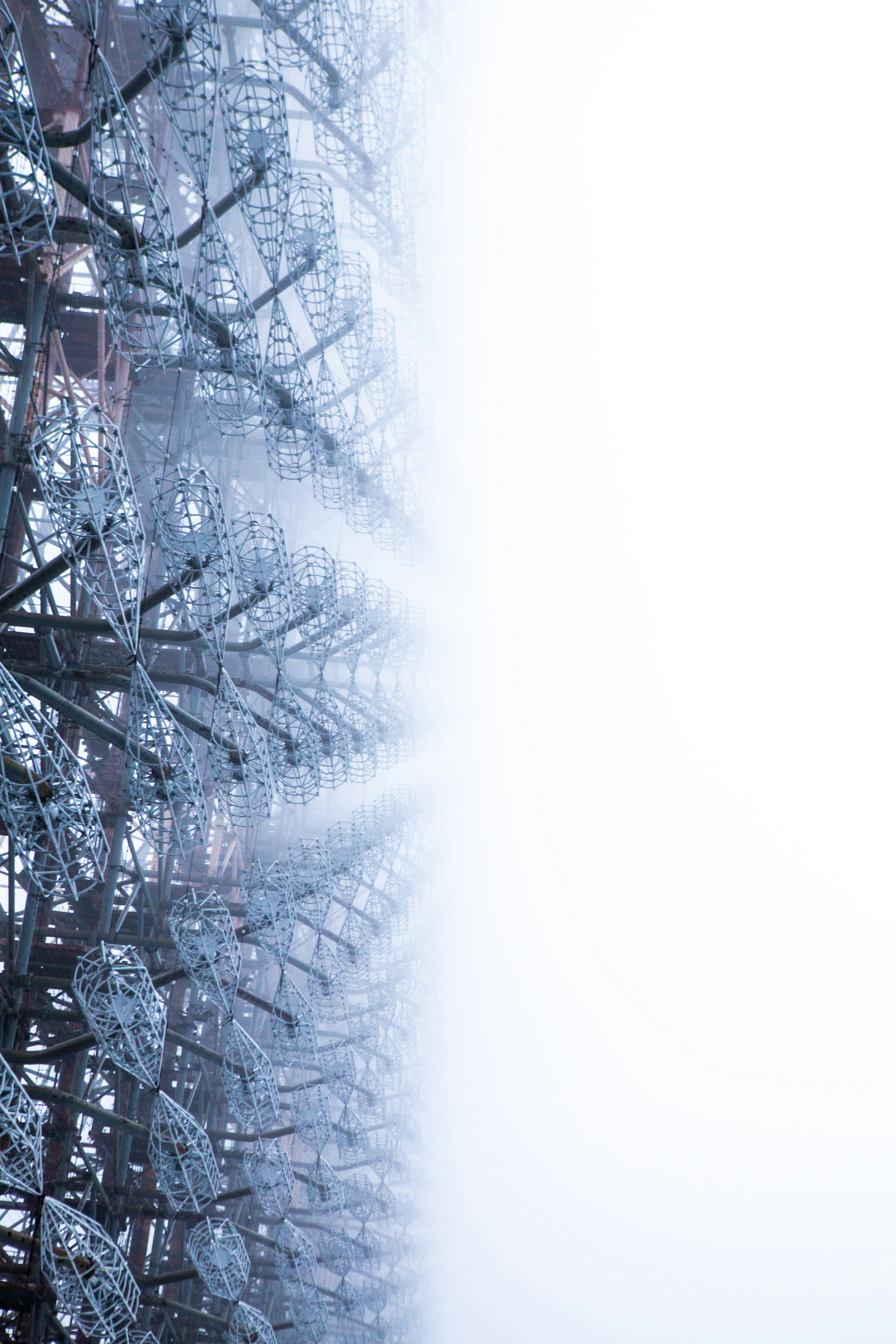 a close up of a metal structure with a sky in the background