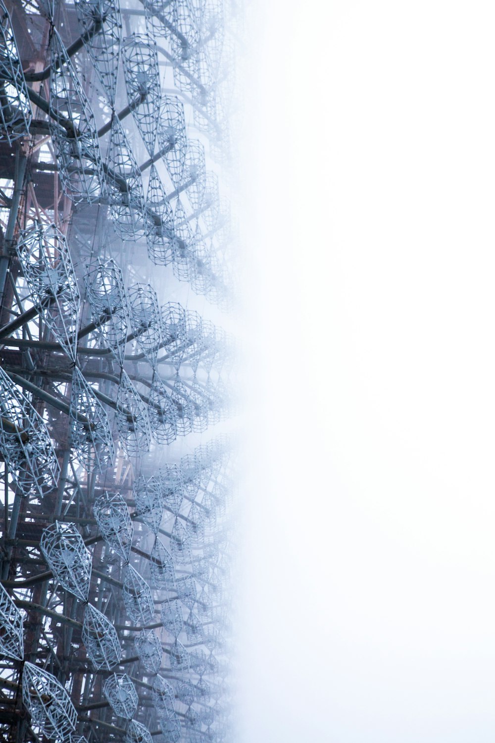 a close up of a metal structure with a sky in the background