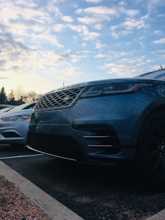 A close-up of a well-maintained pre-owned car parked in the Suncity Auto Sales LLC lot on a sunny day.