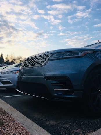 A close-up of a well-maintained pre-owned car parked in the Suncity Auto Sales LLC lot on a sunny day.