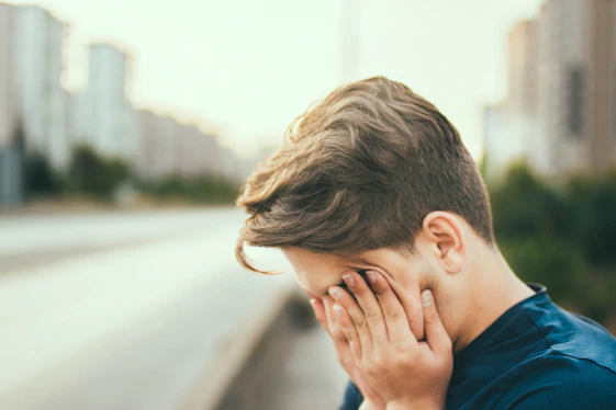 person covering own face