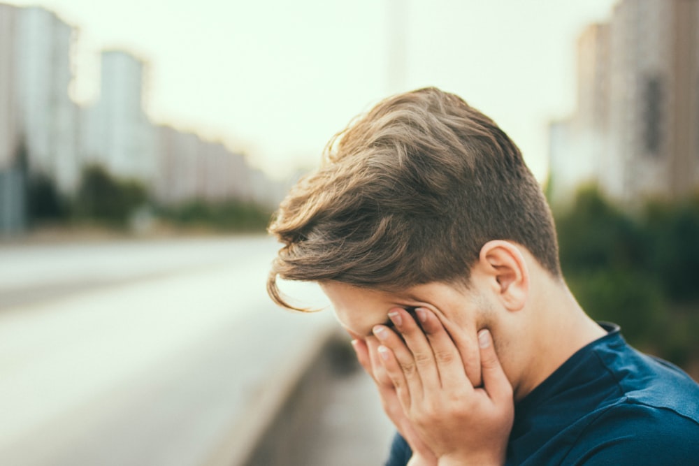 person covering own face